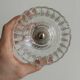 Thick glass bowl on a metal stand.