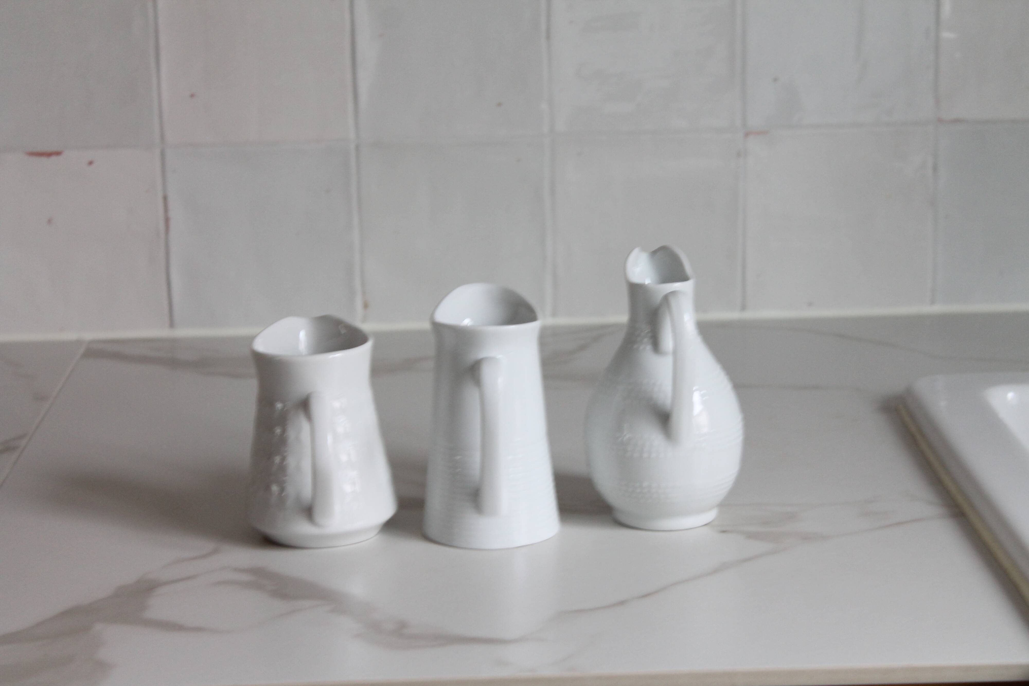3 old French pitchers in white ceramic