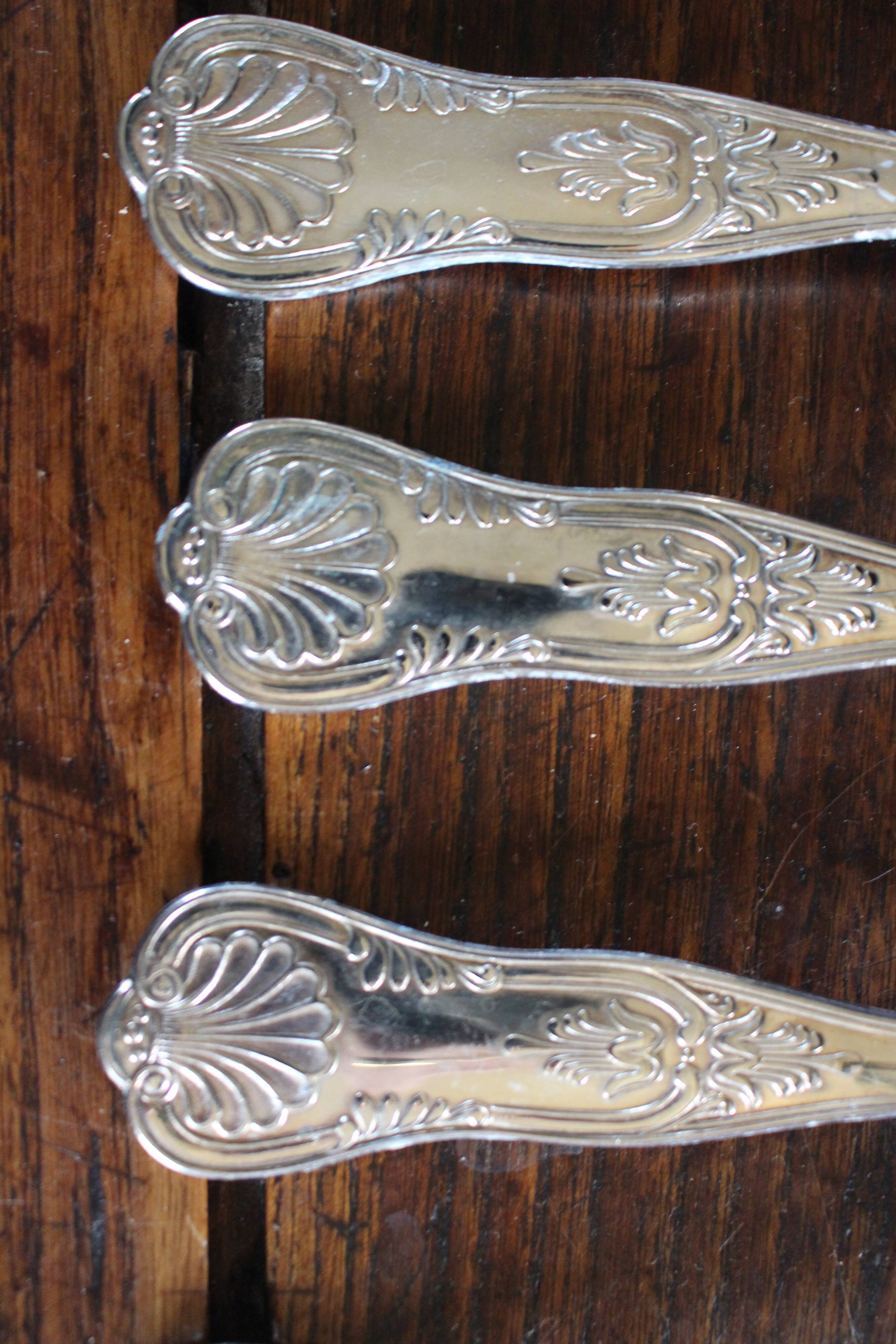 A set of 7 large metal shell spoons