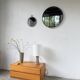 Brutalist round mirror with wrought iron and studs.
