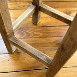 Brutalist stool in raw wood with a weathered effect.