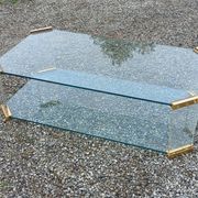 1970s designer coffee table in glass, plexiglass, and gold metal.