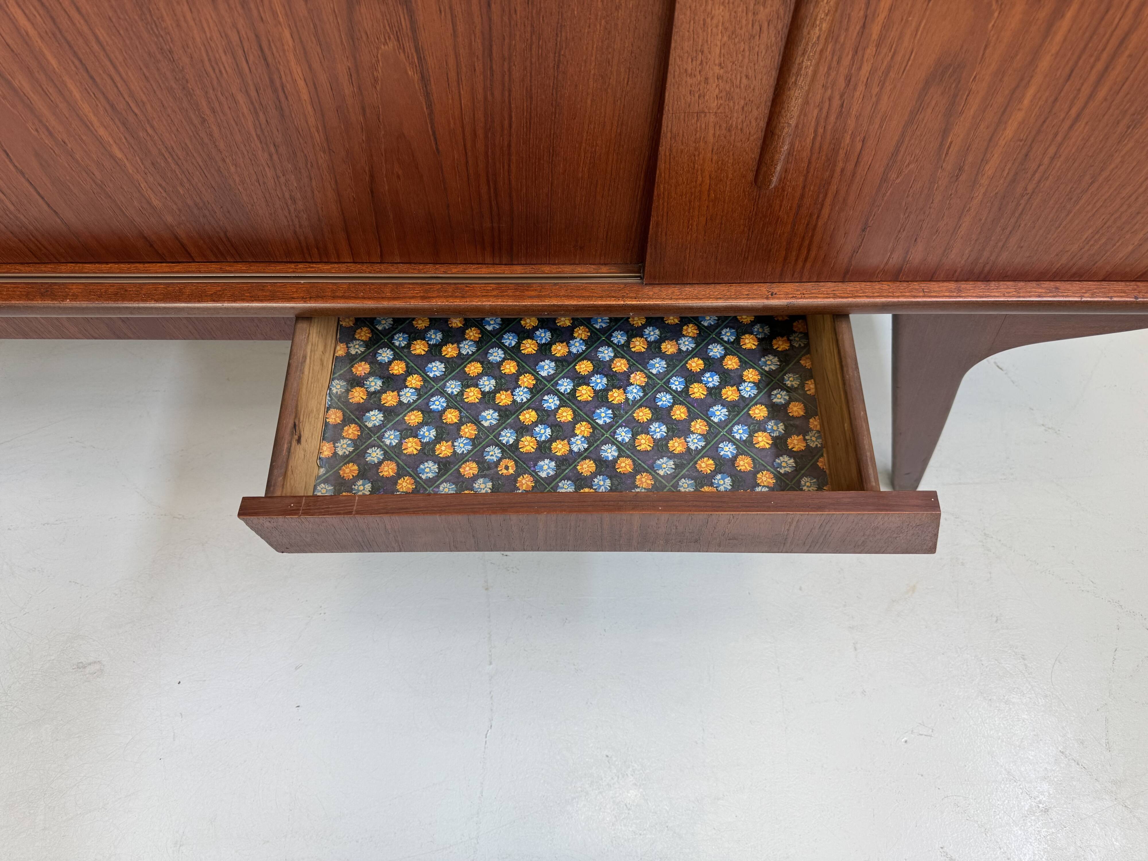 Vintage Danish teak wall unit with sliding doors from the 1960s.