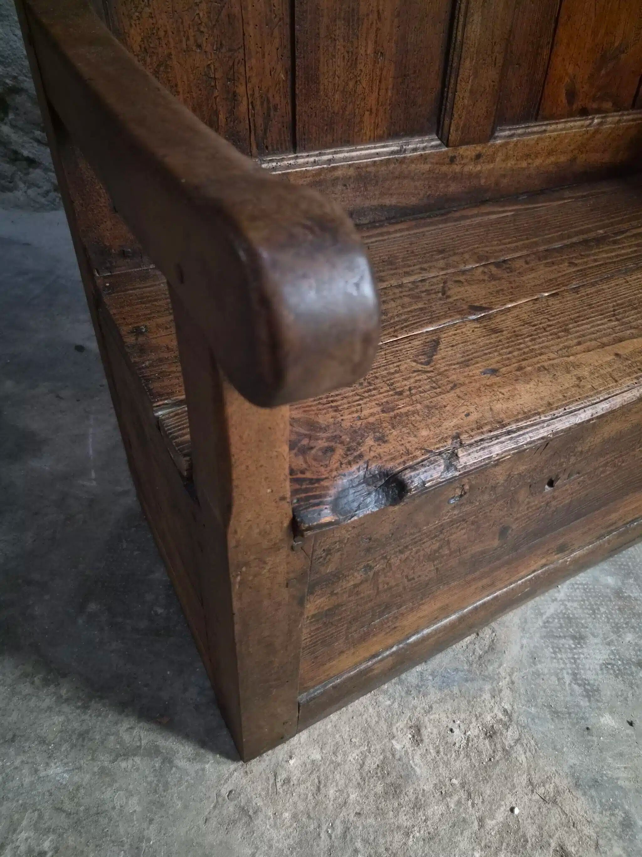 Rustic French antique storage bench from the 18th century in walnut and pine.