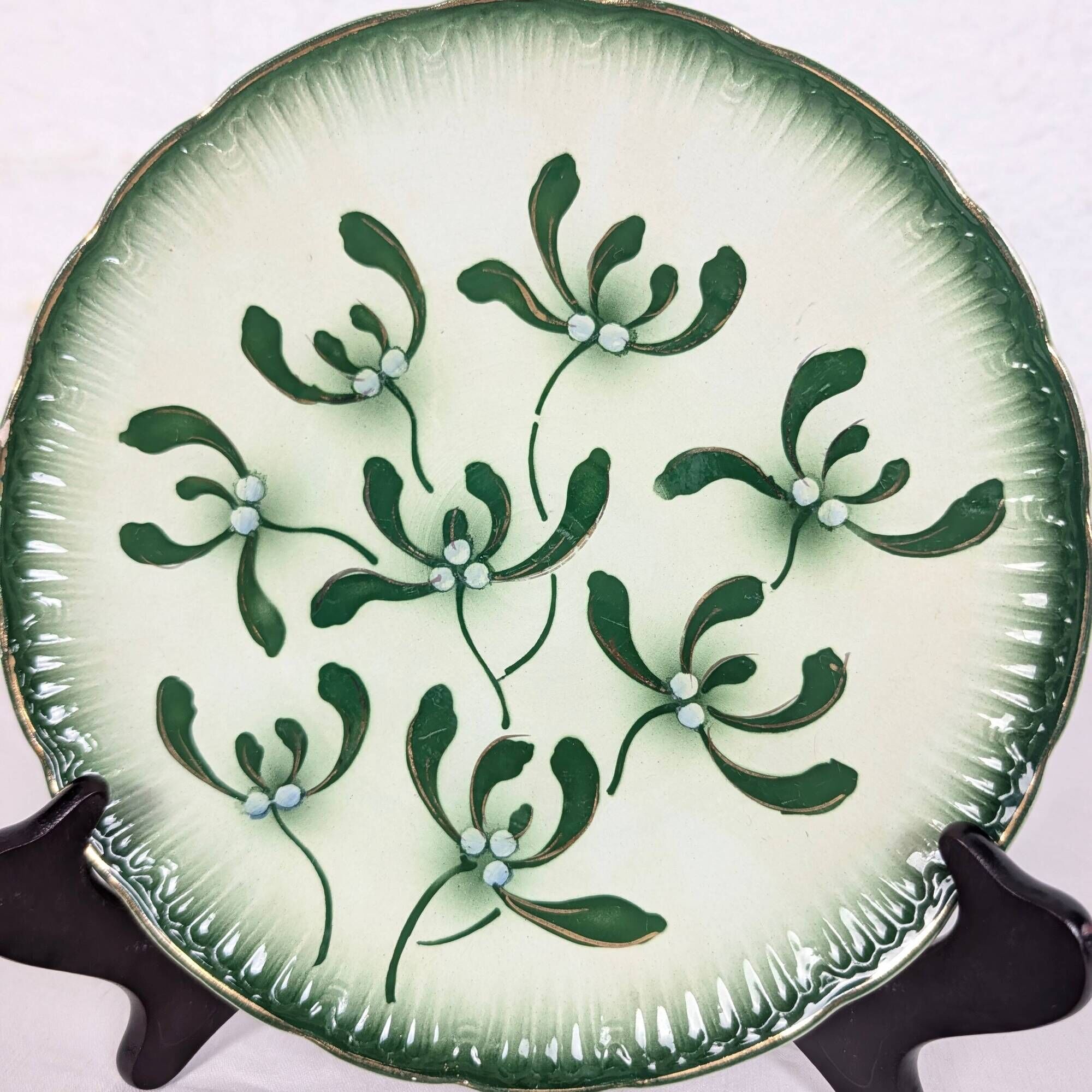 Badonviller plate with a guilloche pattern, green slipware.