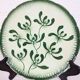 Badonviller plate with a guilloche pattern, green slipware.