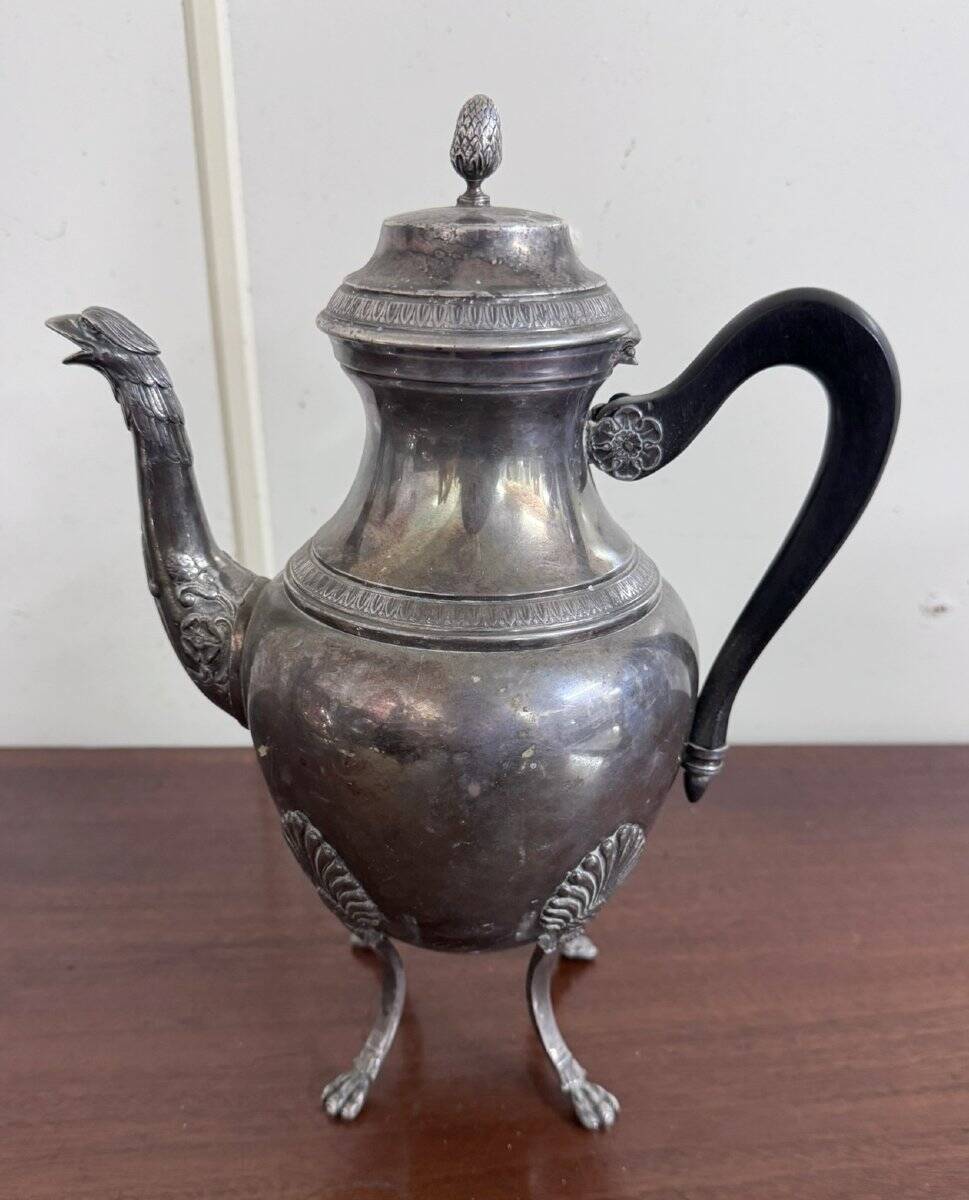 Empire style silver-plated verseuse, resting on three sculpted feet.