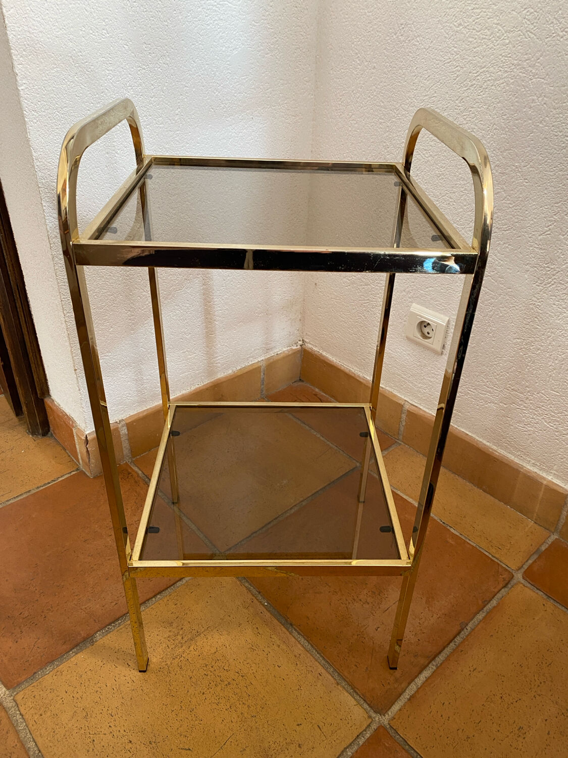 Gold metal and smoked glass console table.