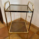Gold metal and smoked glass console table.