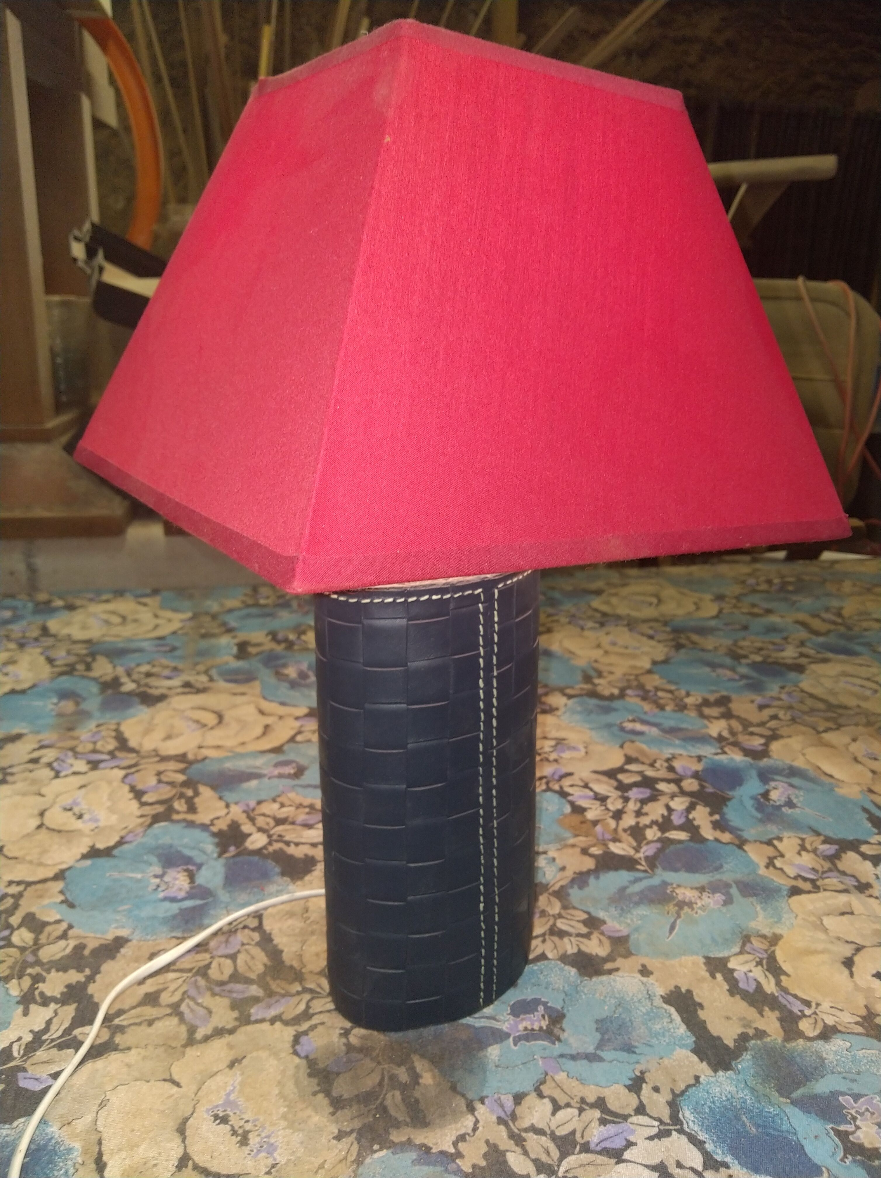 Ovoid lamp sheathed in braided blue leather and saddle stitching