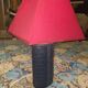 Ovoid lamp sheathed in braided blue leather and saddle stitching