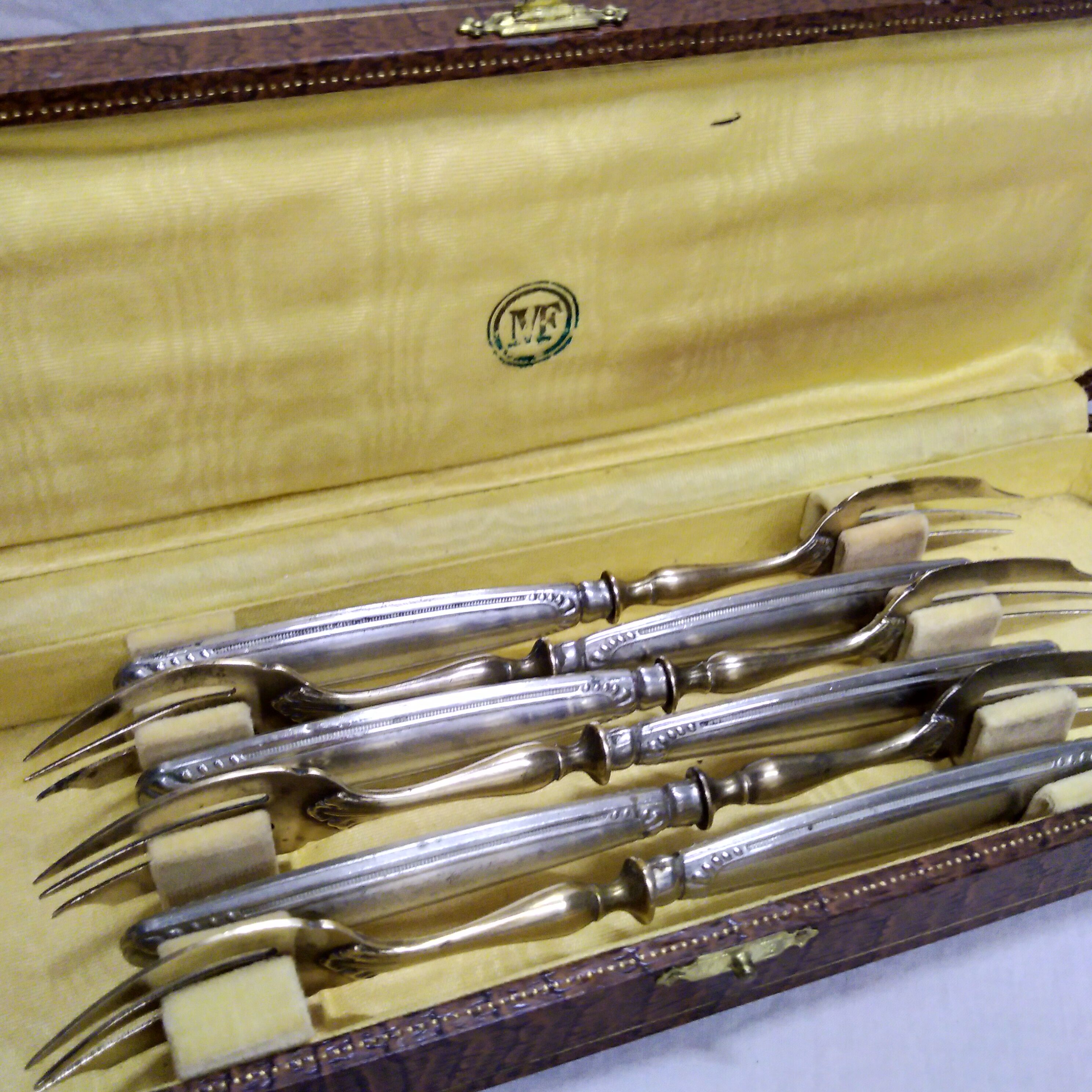 Silver and gold cake fork service