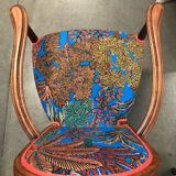 Art Nouveau armchair with a floral seat and backrest.
