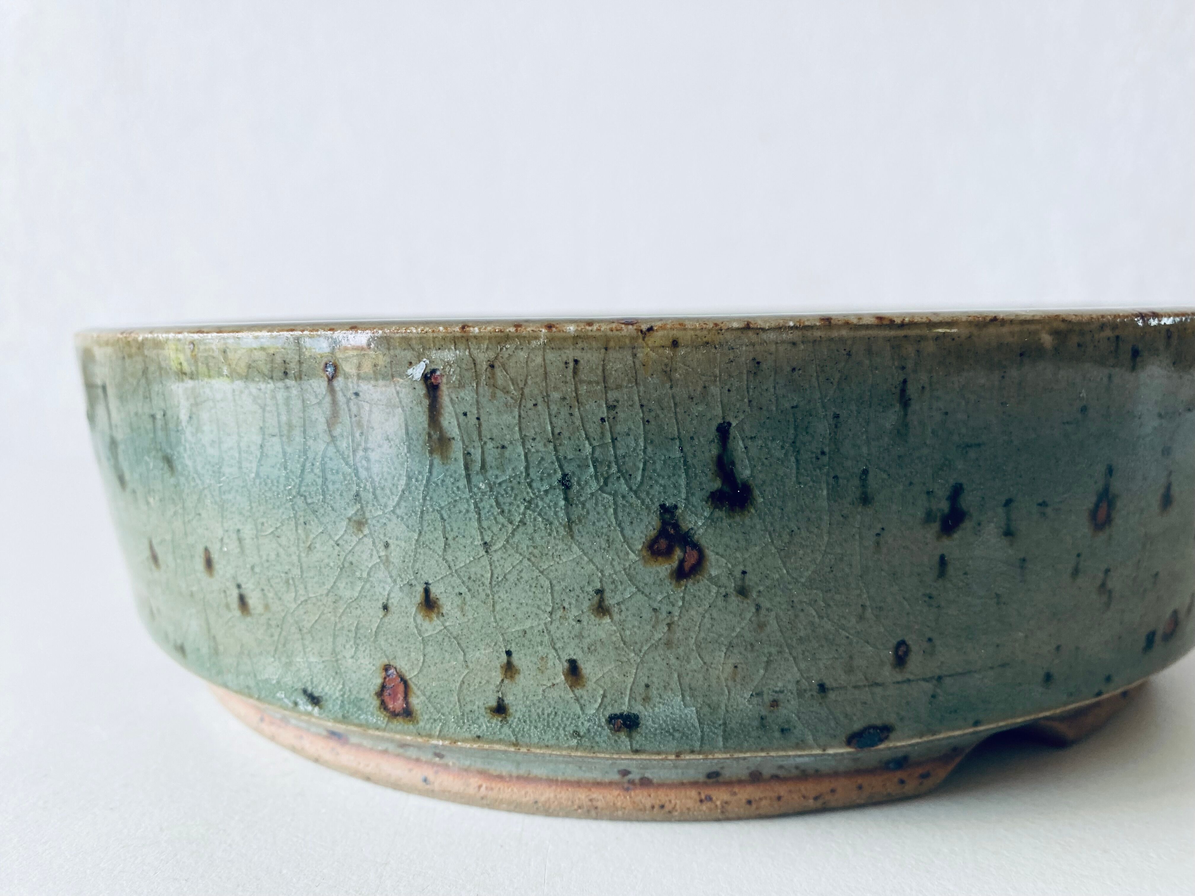 Pierced glazed stoneware cup