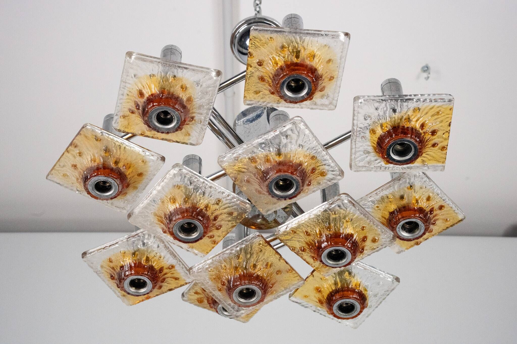 12-light Mazzega chandelier in amber and clear murano glass and chrome. Ita