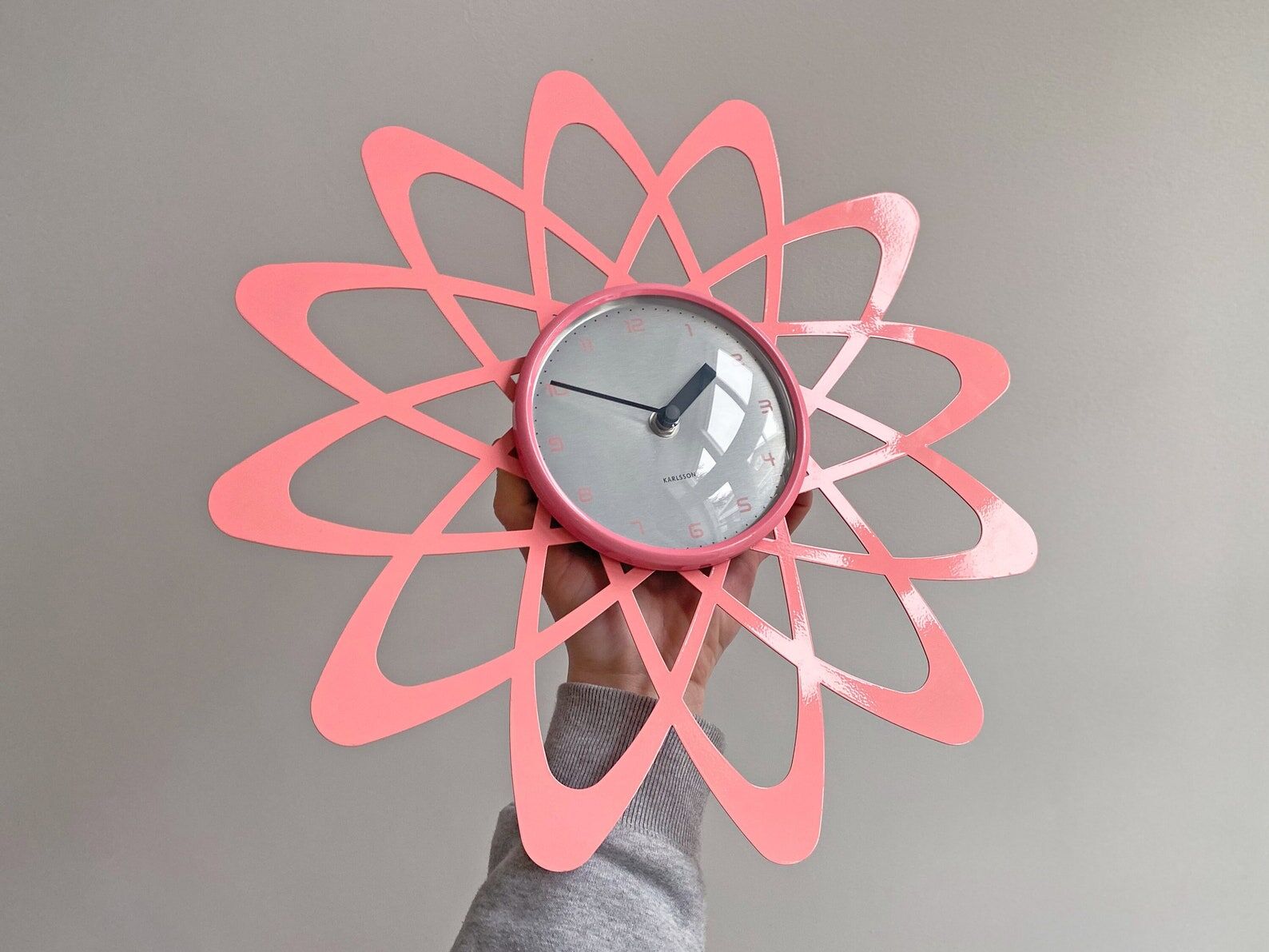 Pink Karlsson wall clock in a mid century shape