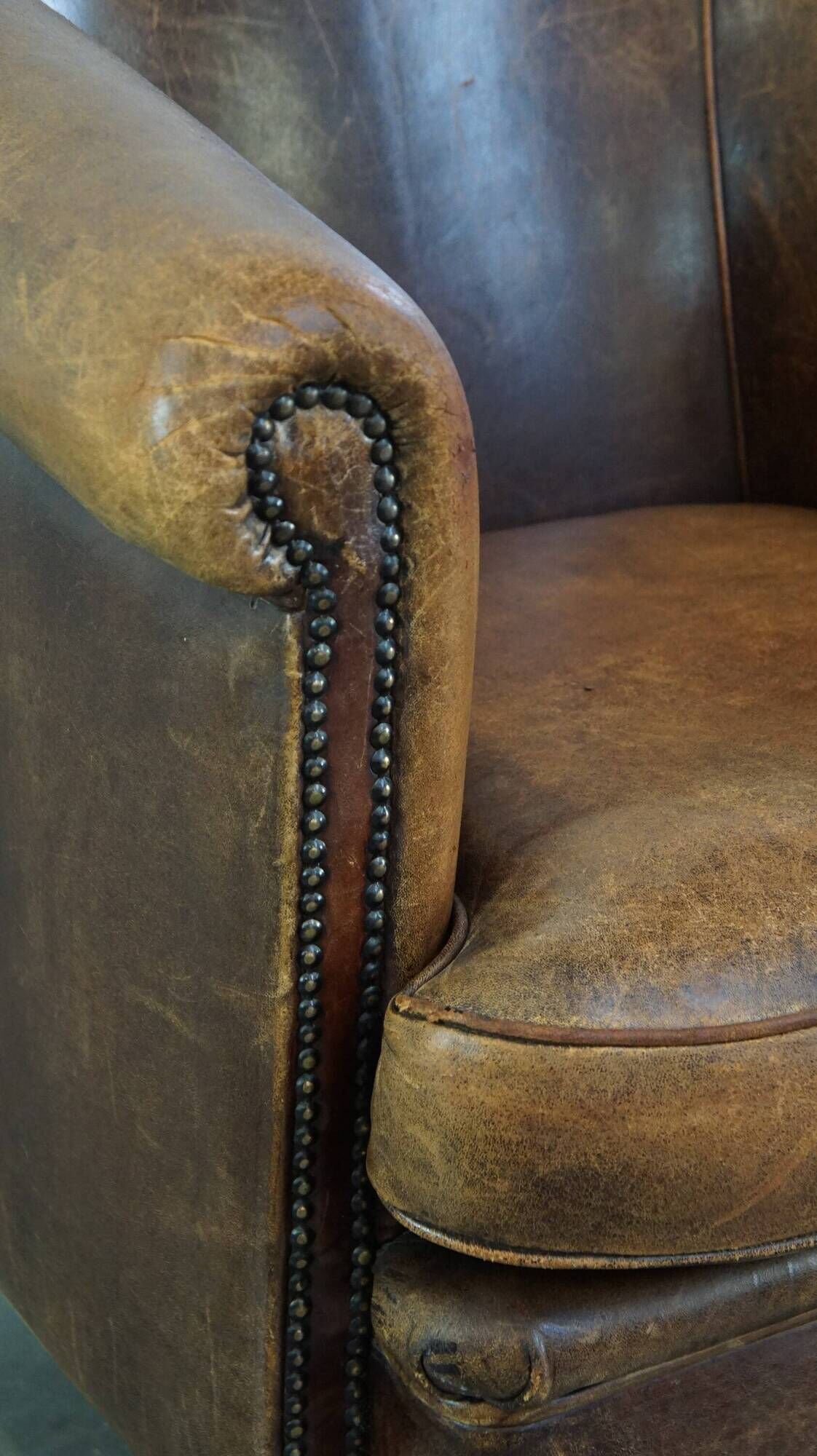 Characterful sheepskin leather club armchair with a luxurious, rustic appearance