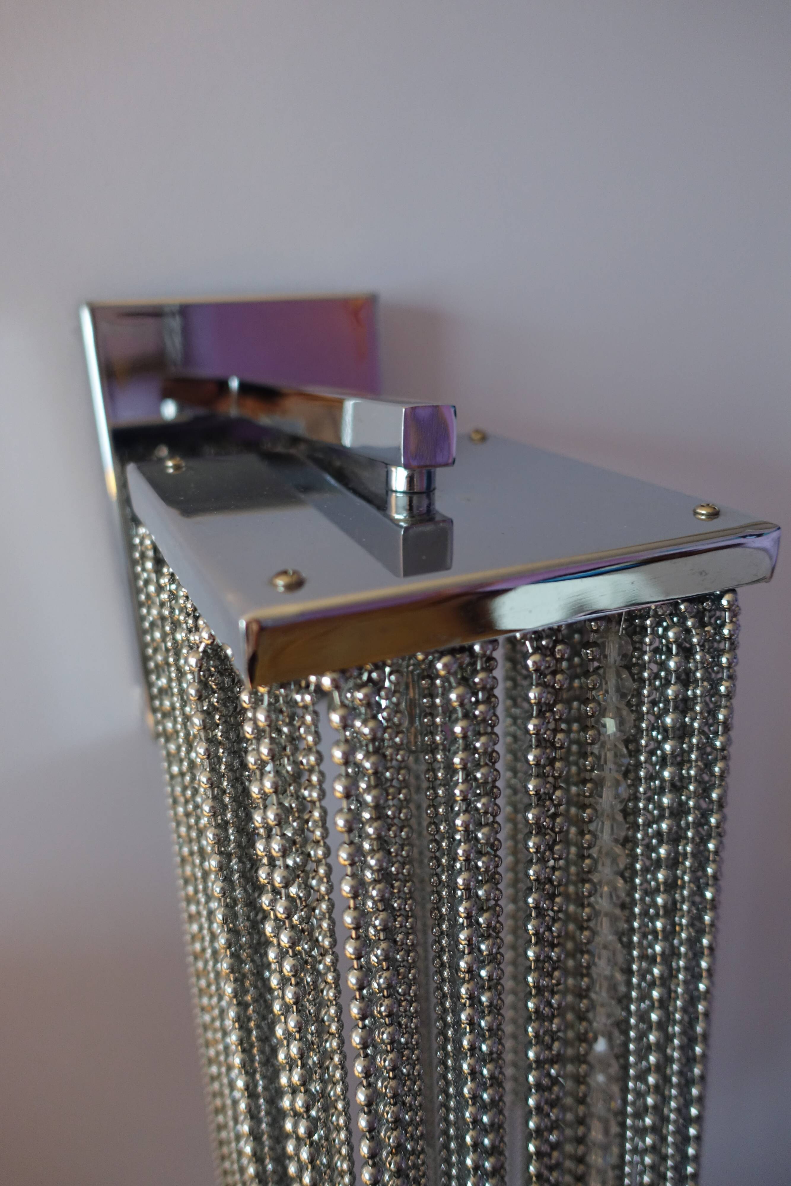 Swarovski wall lamp in silver-plated metal with crystal pendants.