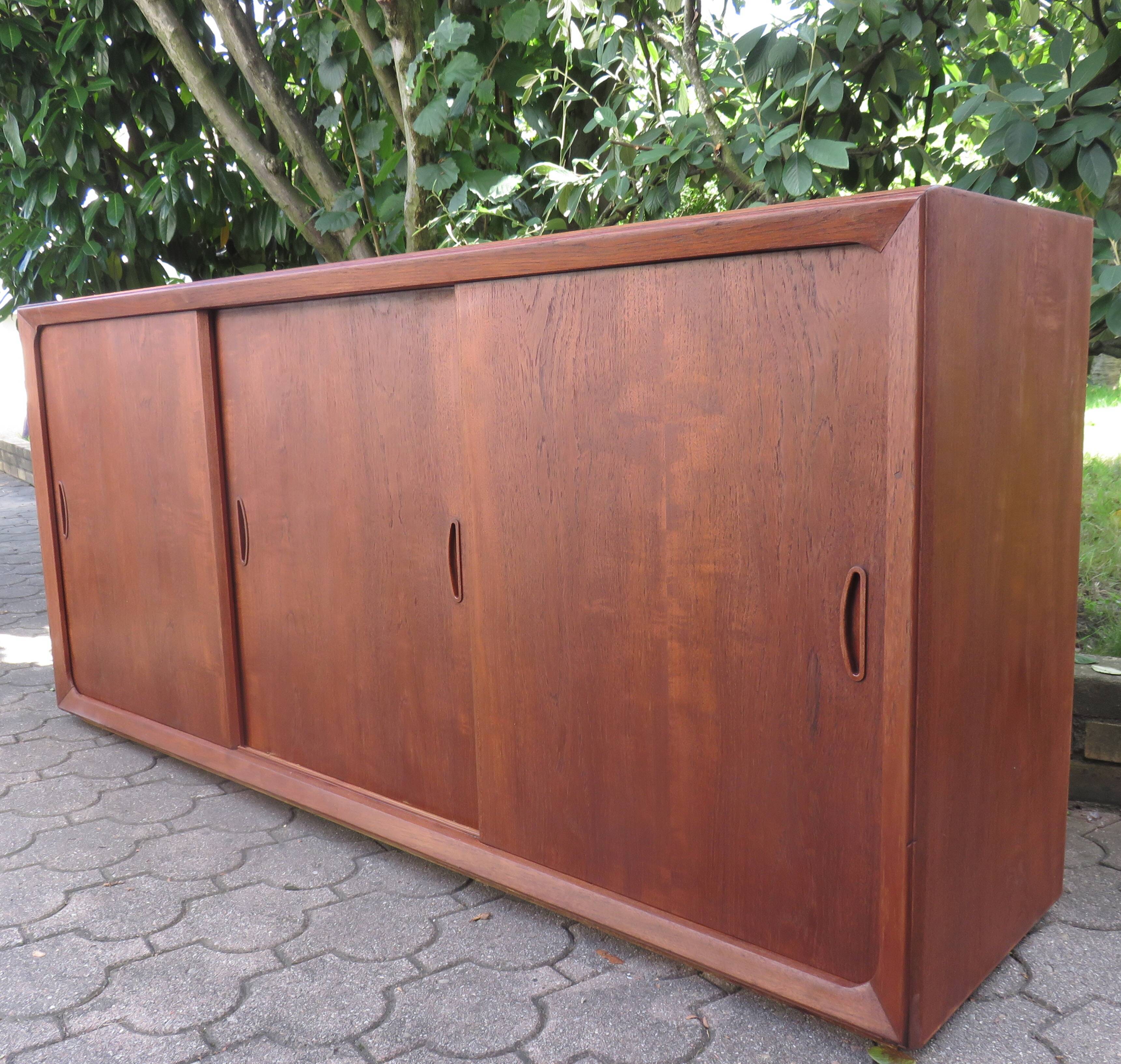 Low sideboard with 3 sliding doors in teak. Denmark 1960