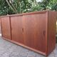 Low sideboard with 3 sliding doors in teak. Denmark 1960