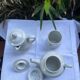 Antique white earthenware teapot, individual service with filter.