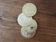 Set of 4 coasters in the shape of coins, in gold metal.