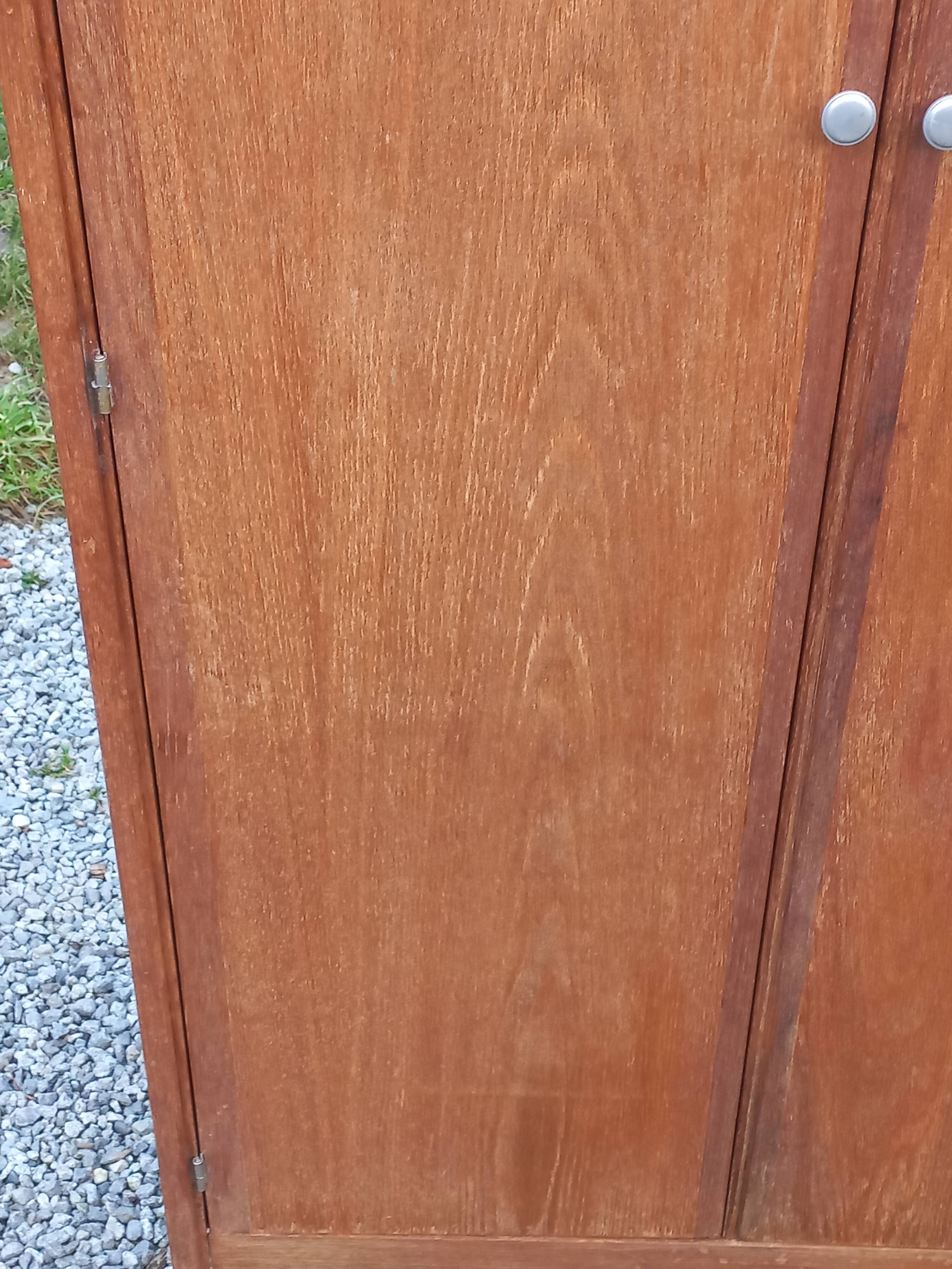 Vintage oak wardrobe with metal legs from the 1950s.