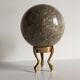 Marble ball paperweight on vintage brass
