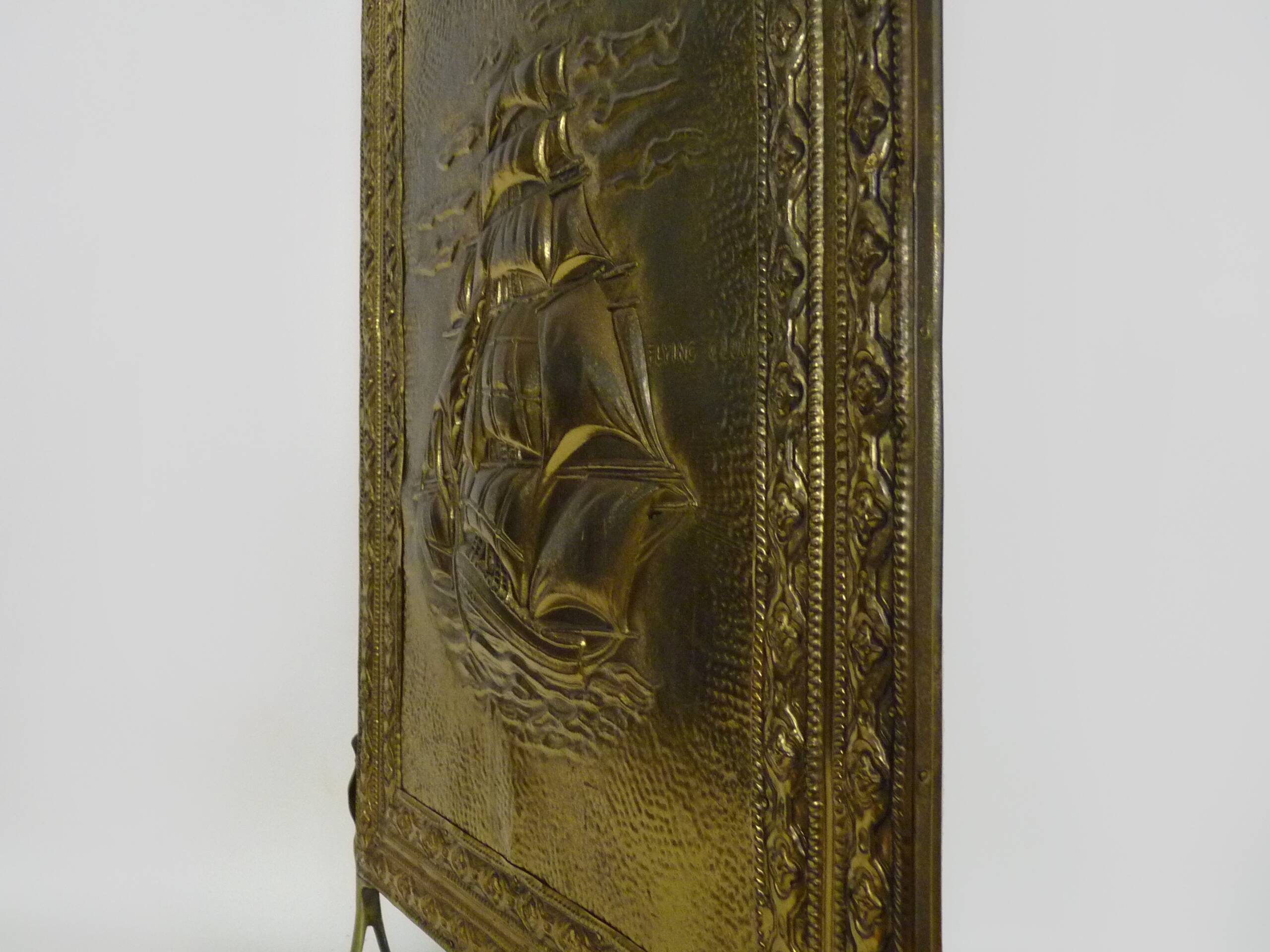 Fireplace screen in repoussé brass with a sailing boat. 1960s.