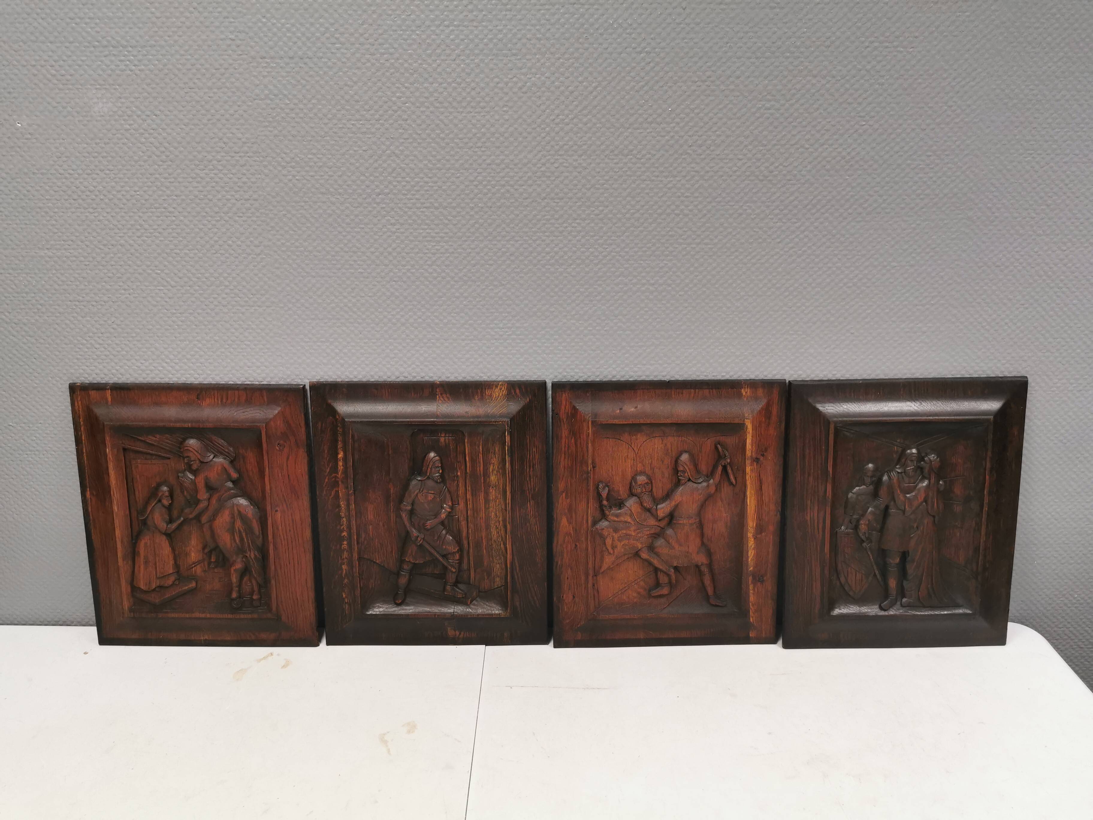 Four old wooden carvings to hang on the wall.