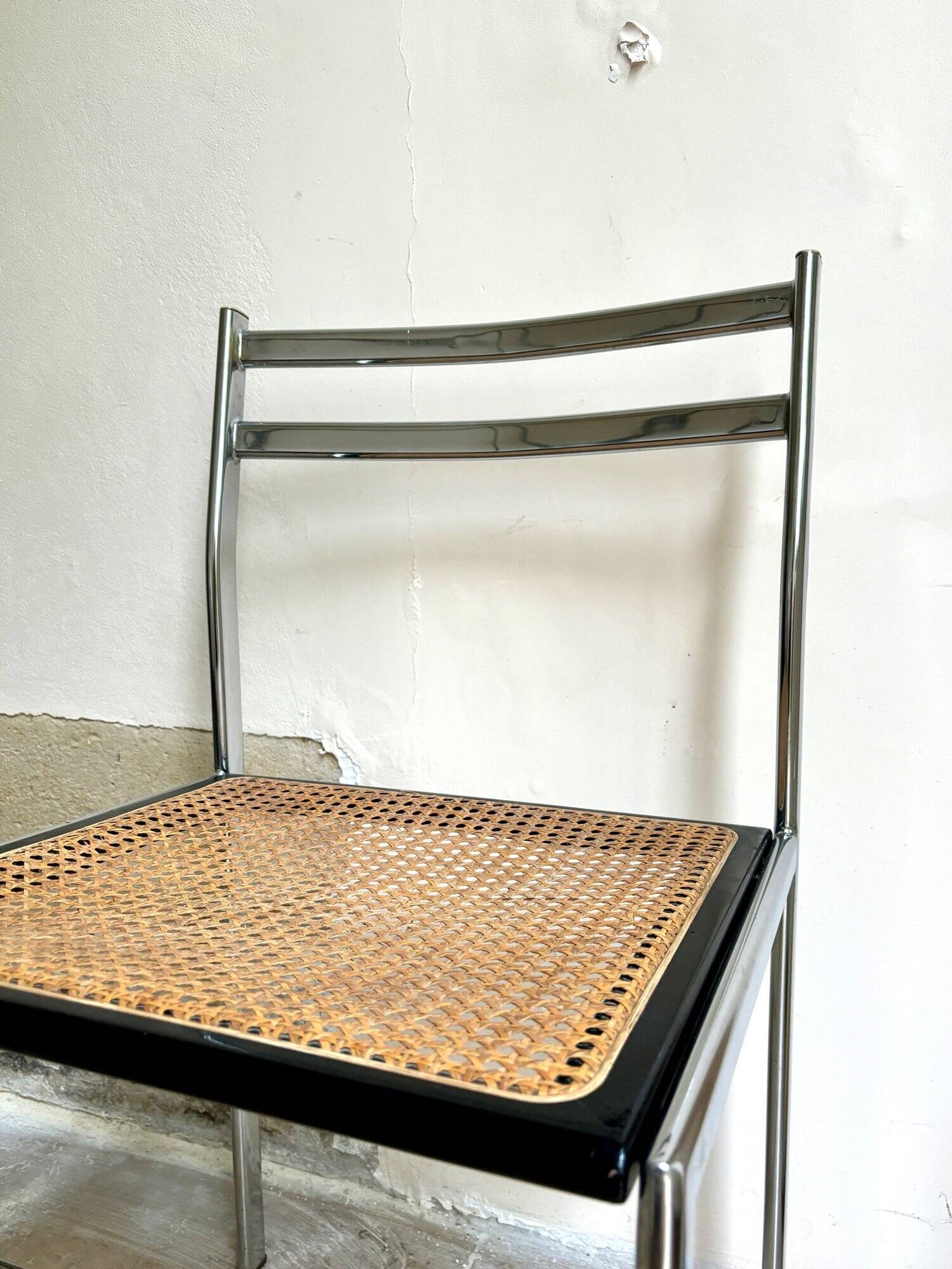 Chair in chrome metal, black wood and canework