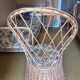 Vintage shell chair in woven rattan with original cushion.