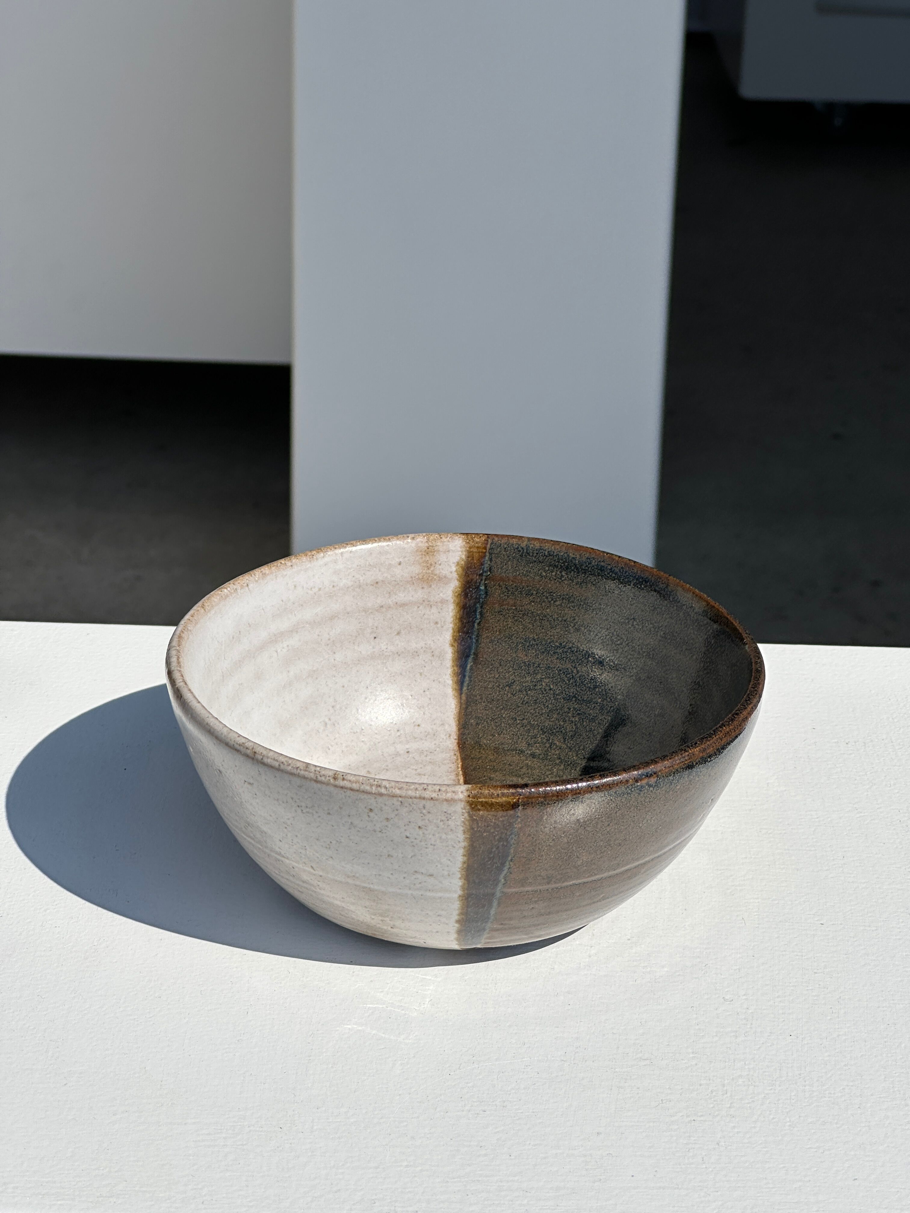 White and glossy brown two-tone ceramic bowl, matt earth