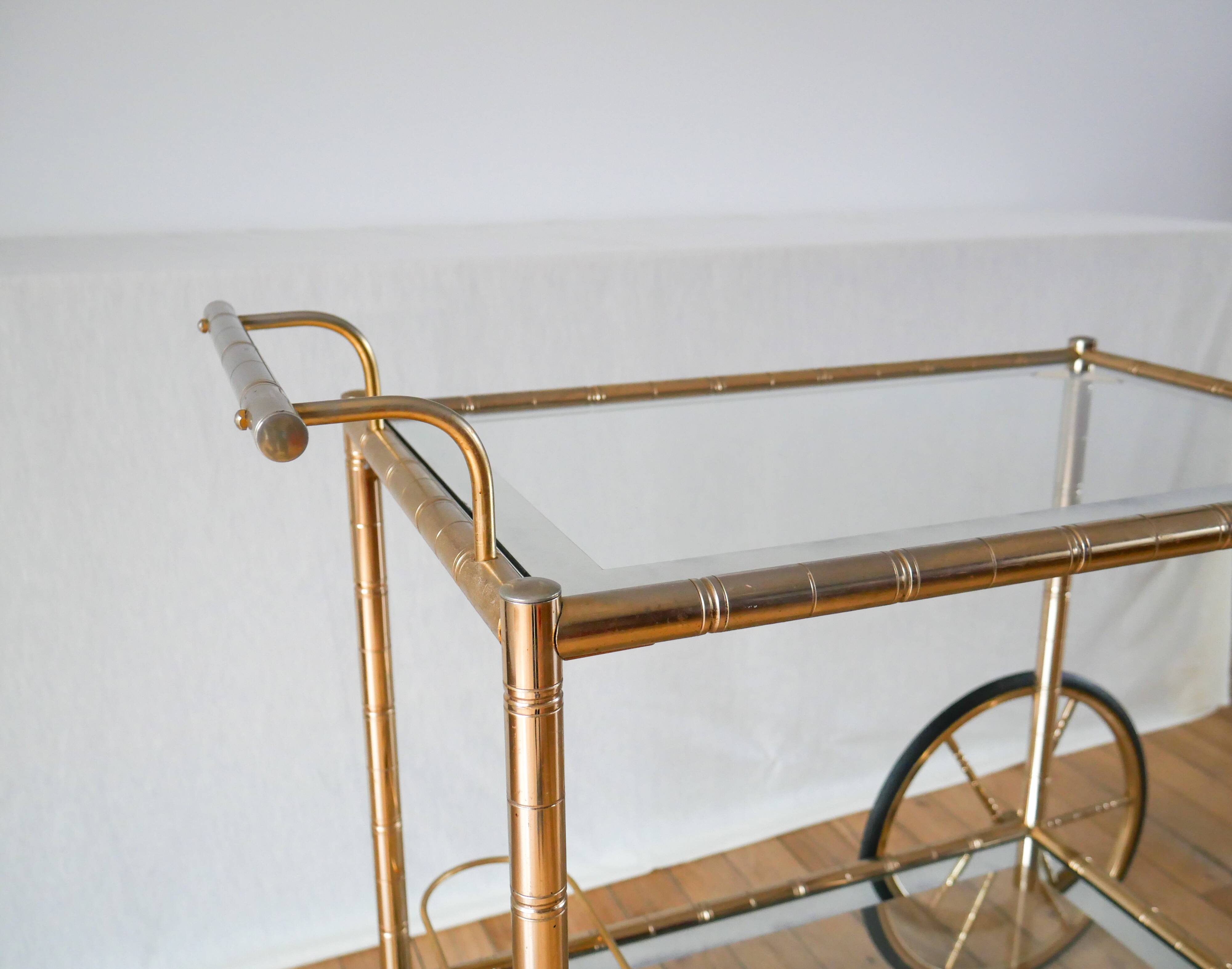 Serving table in gilded metal and glass with large wheels 1950