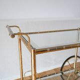Serving table in gilded metal and glass with large wheels 1950