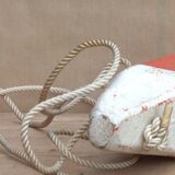 Old red and white wooden buoy