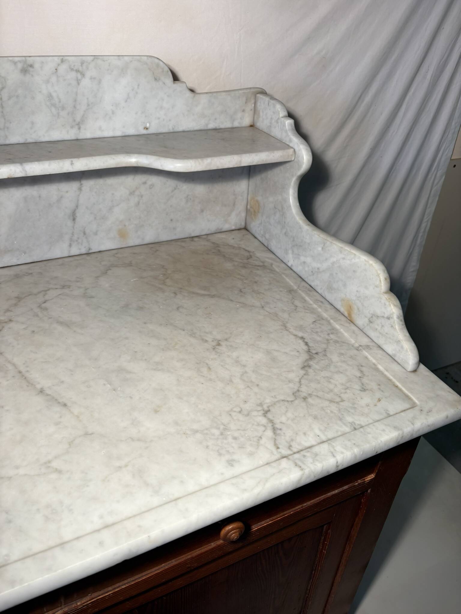 Antique wood and marble kitchen sideboard with carved backsplash