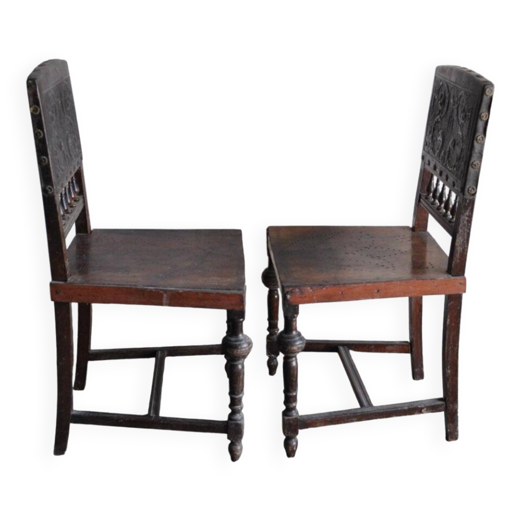 Pair of antique wooden and brown leather dining chairs, brass studs.