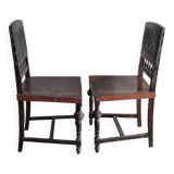 Pair of antique wooden and brown leather dining chairs, brass studs.