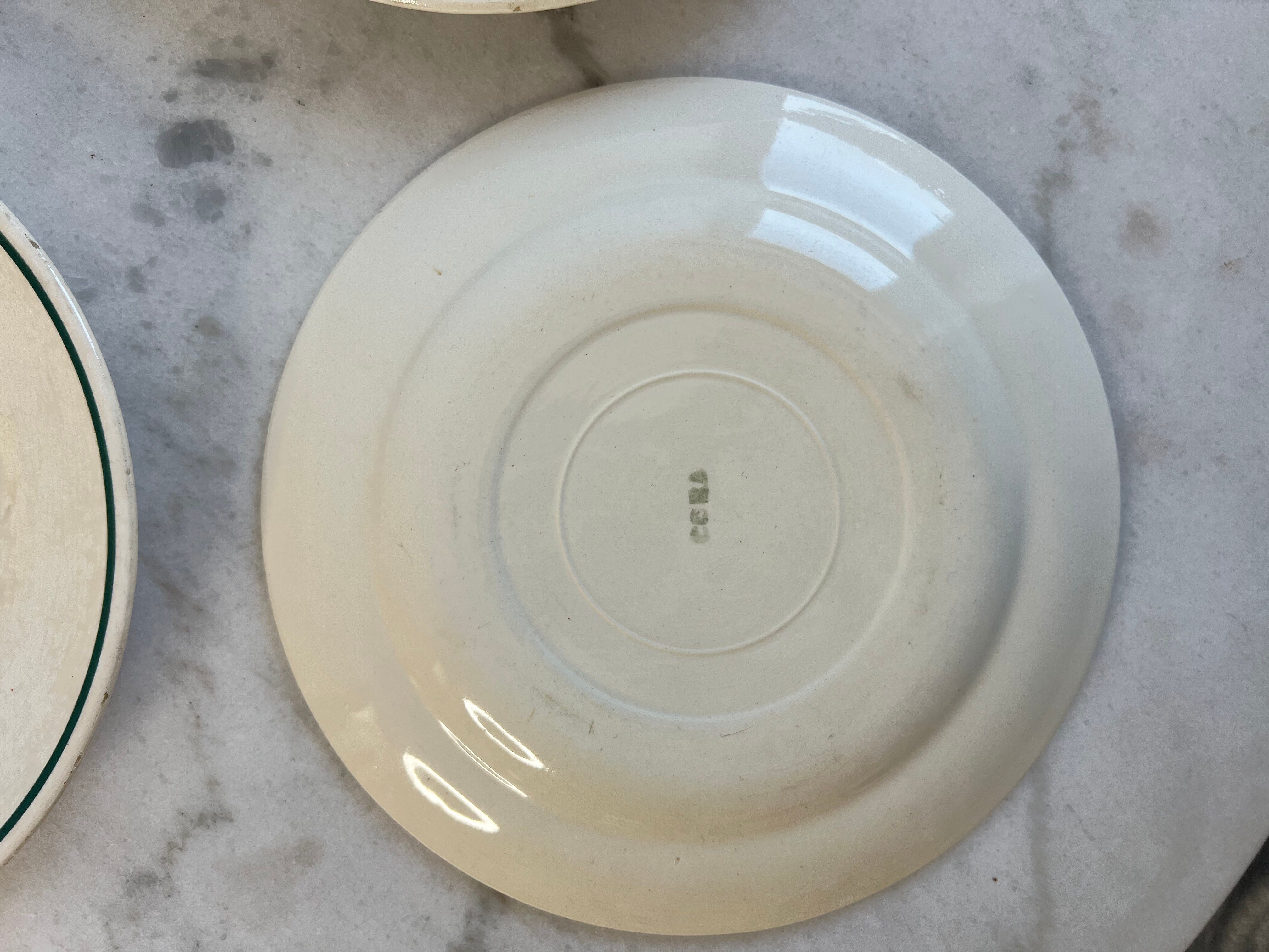 Set of 4 small flat plates with floral designs.