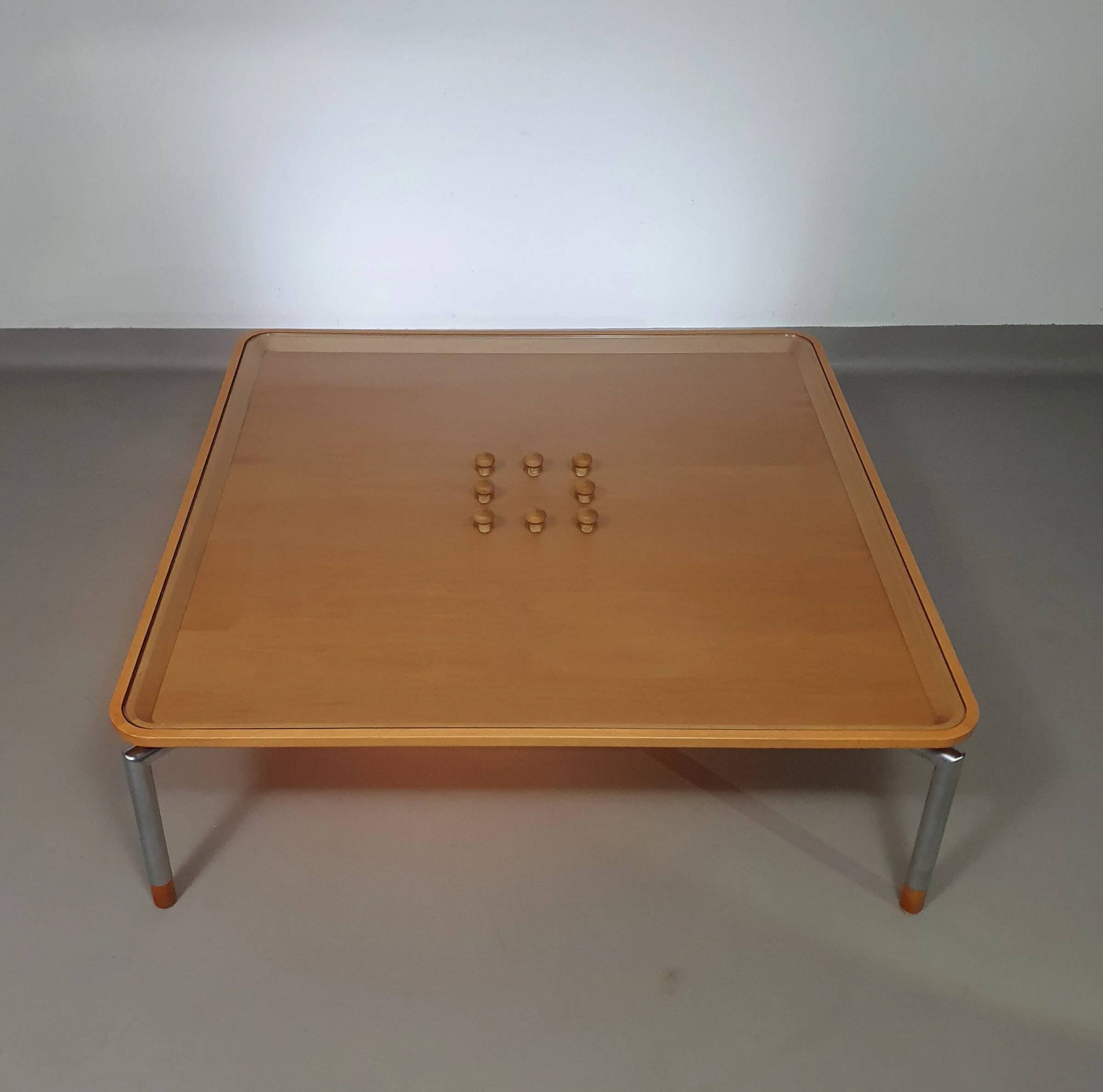 Rare coffee table 110 x 110 x height 35 cm with 8 flange wooden / cork caps in the glass top.