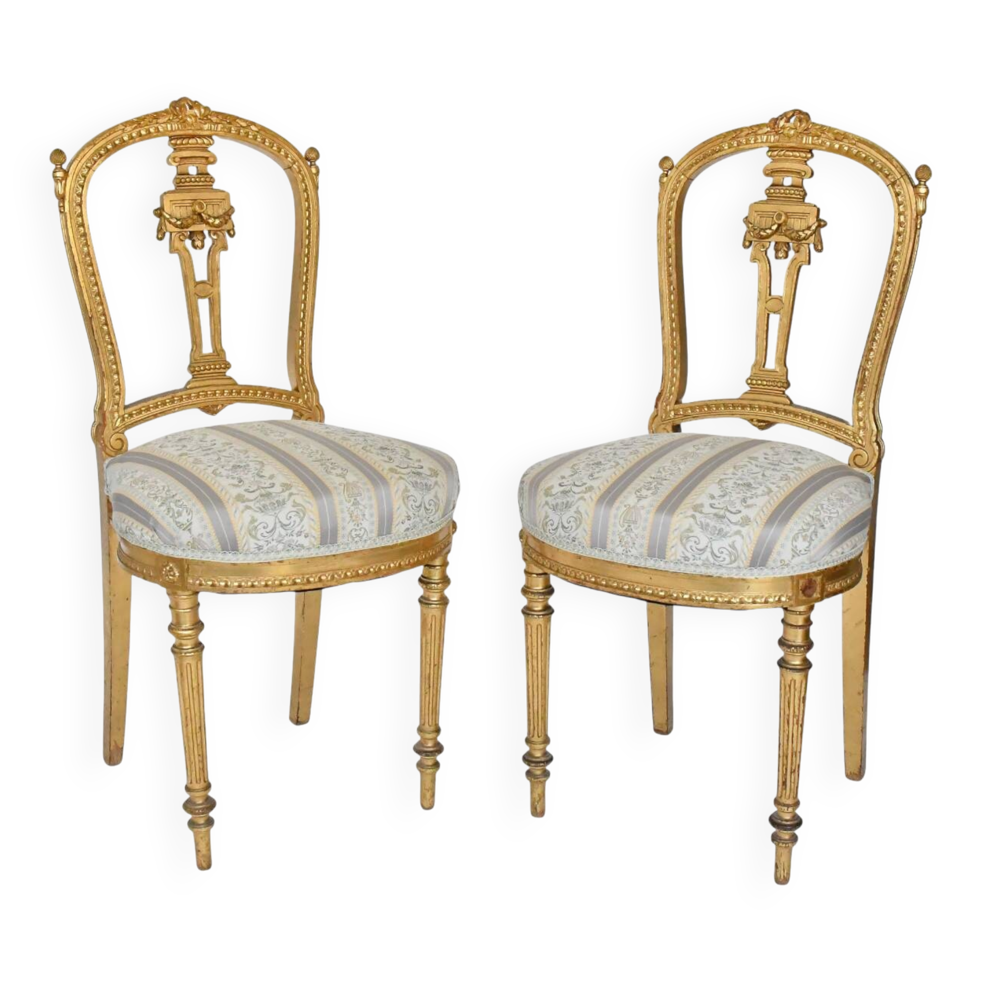 Pair of Louis XVI style chairs in gilded wood.