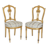 Pair of Louis XVI style chairs in gilded wood.