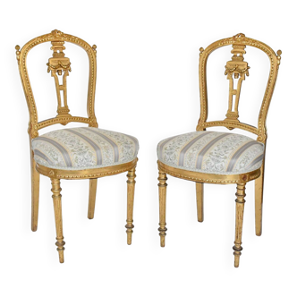 Pair of Louis XVI style chairs in gilded wood.