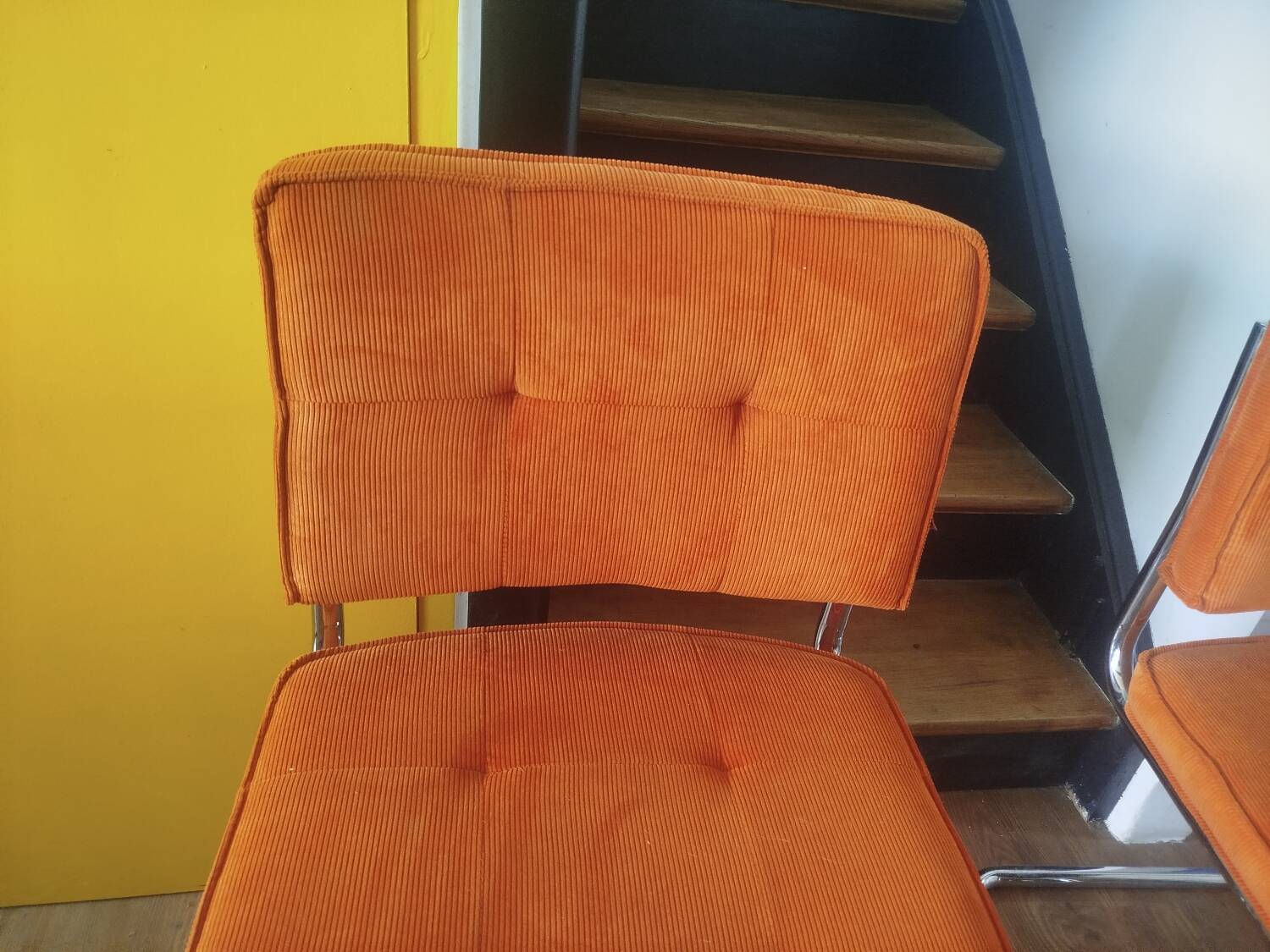 Pair of vintage cantilever chairs in chrome and orange corduroy.