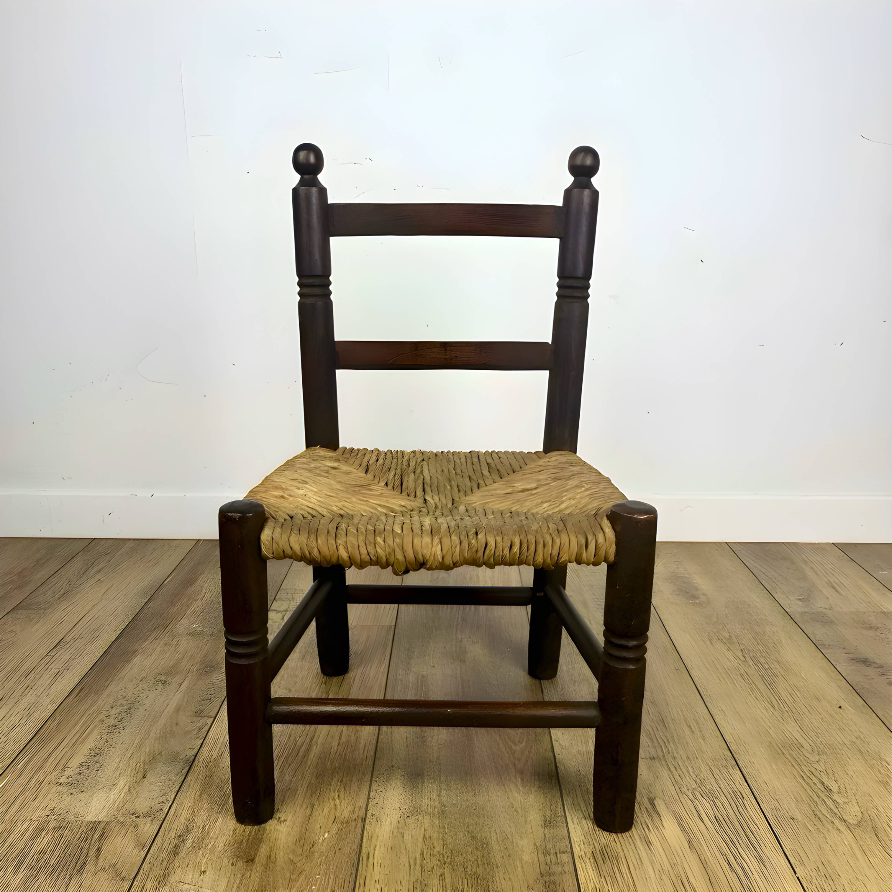 Pair of old wooden and straw children's chairs.