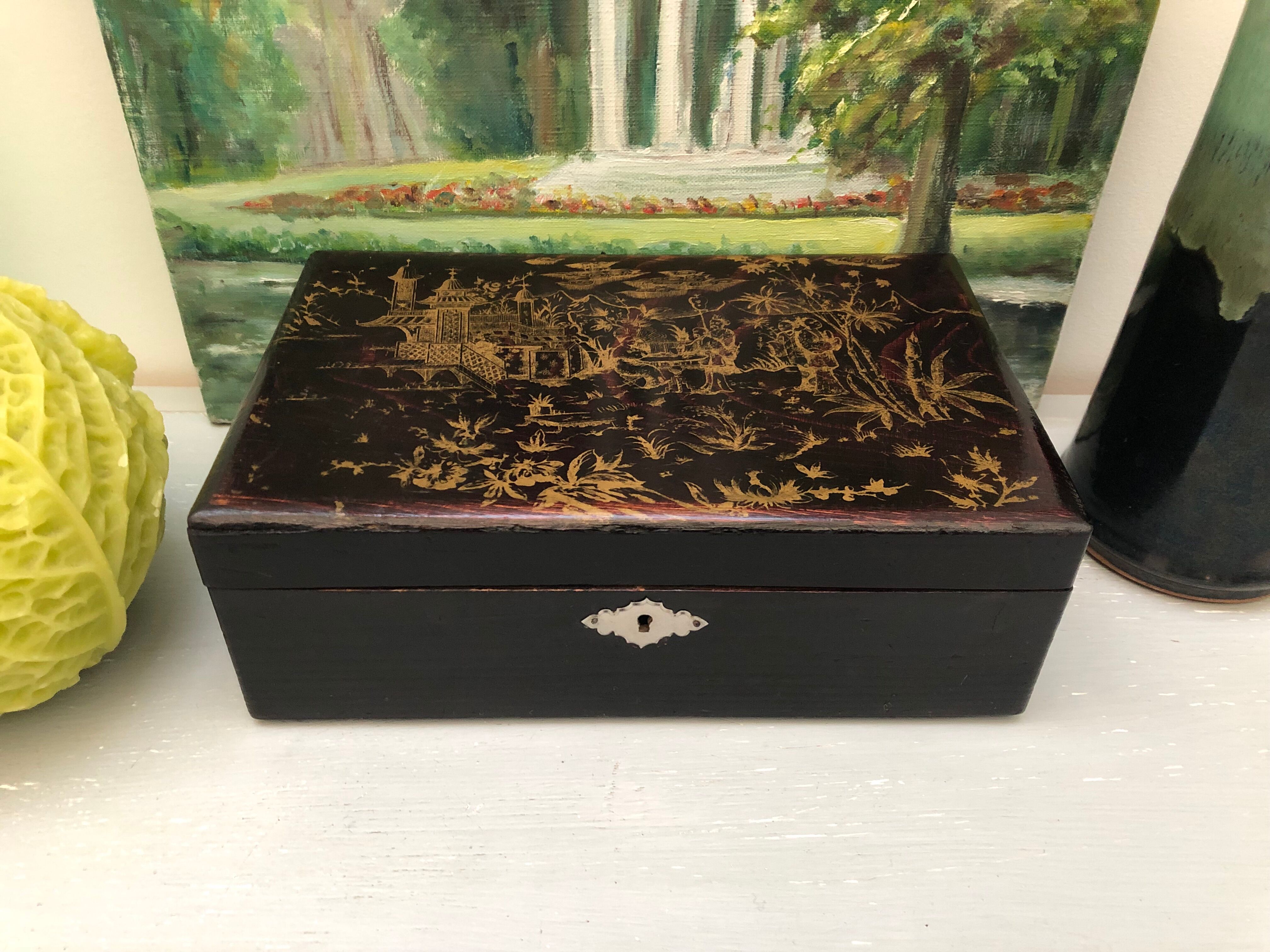 Old black wooden box with Asian décor