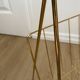 Vintage magazine rack in gold metal with white plastic handle. 60s.