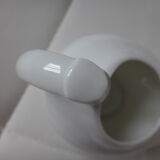 Old white porcelain pourer