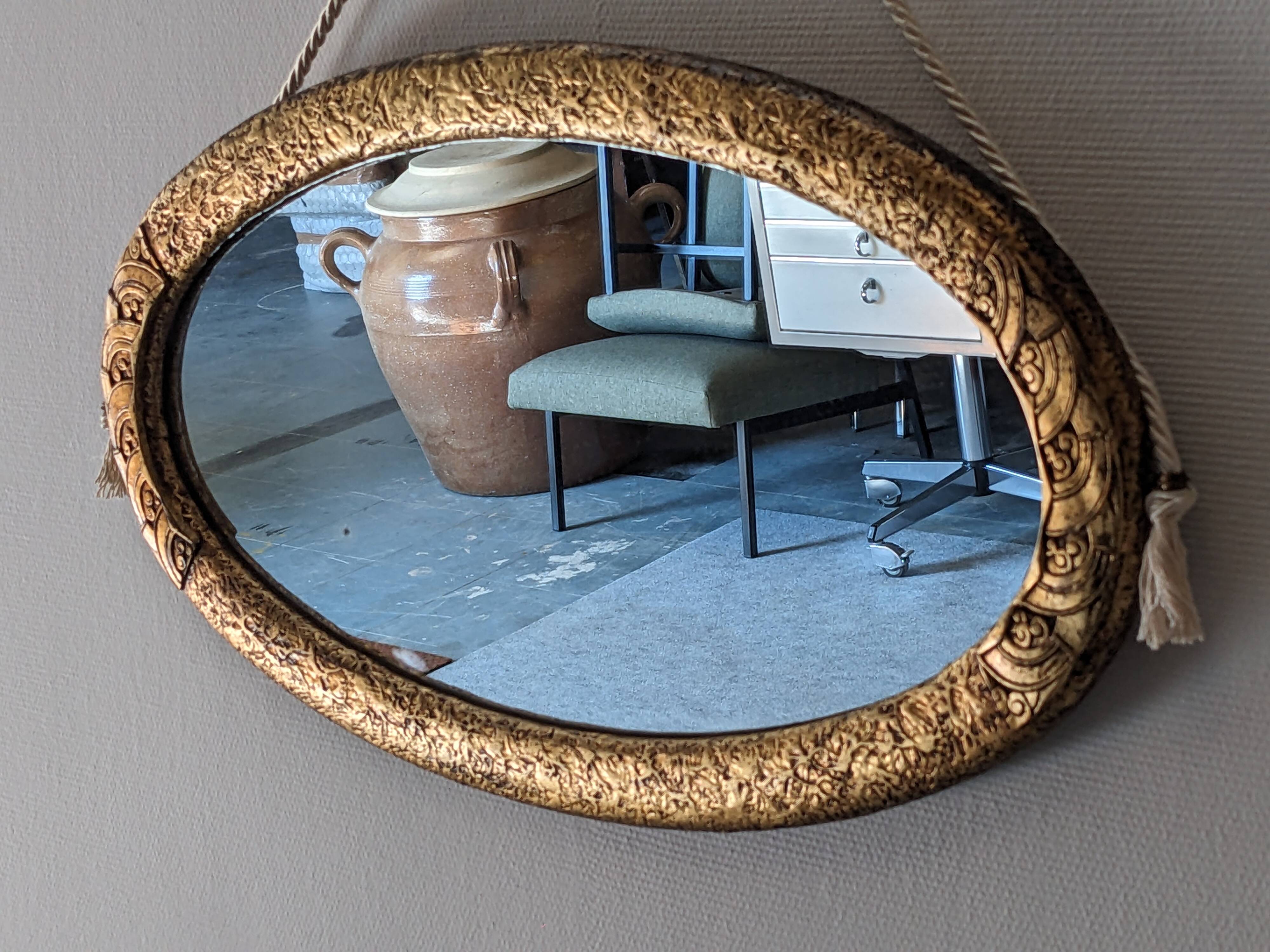Art Deco oval mirror in gilded wood, France circa 1920
